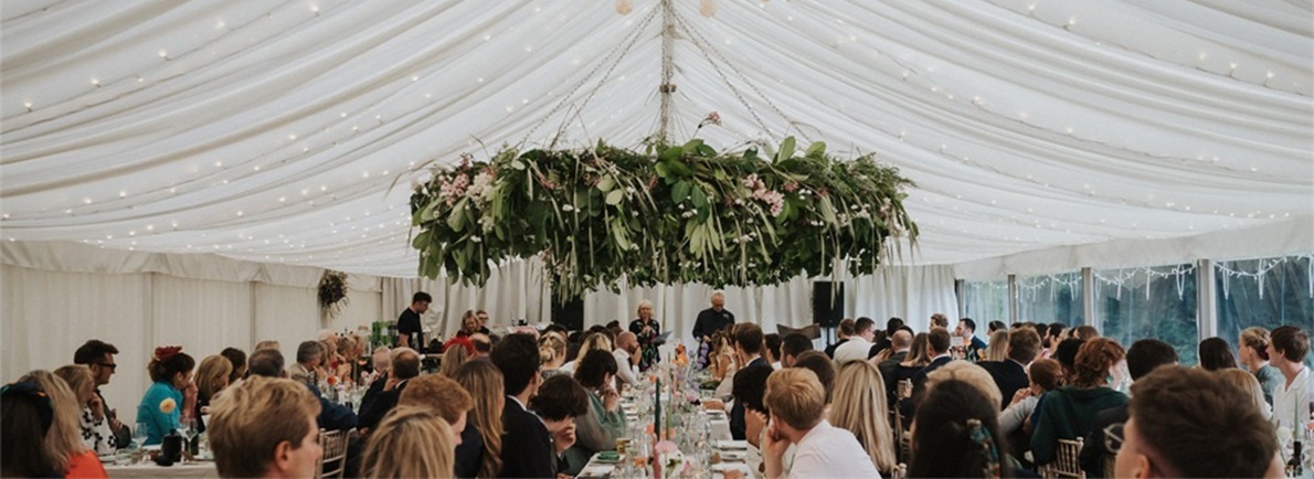 Luxury clear span wedding marquee reception with lighting and dining tables